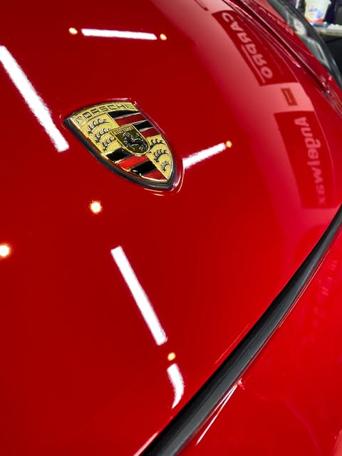 Cofre de Porsche rojo con acabado espejo después del detallado